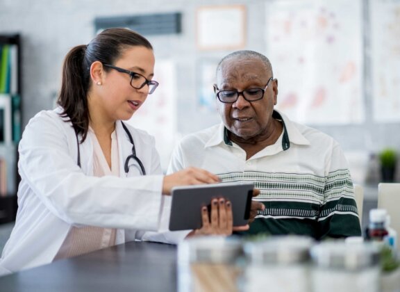 Female doctor reviewing treatment with male patient
