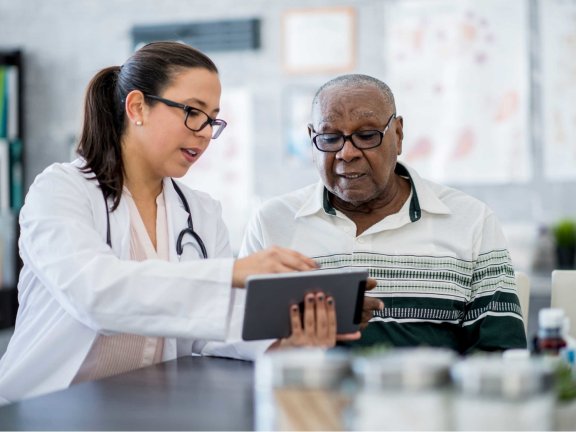 Female doctor reviewing treatment with male patient