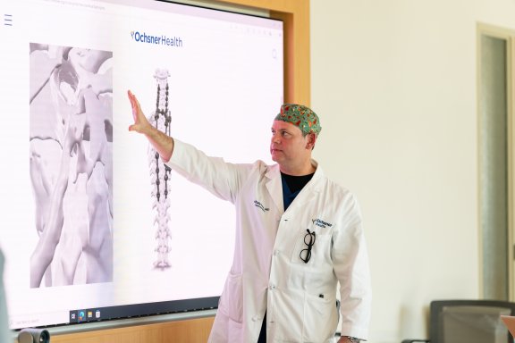 doctor looking at image of spine on computer