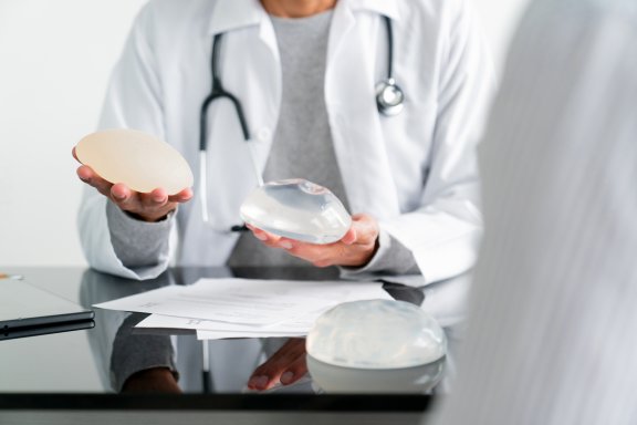 Doctor showing patient breast filler
