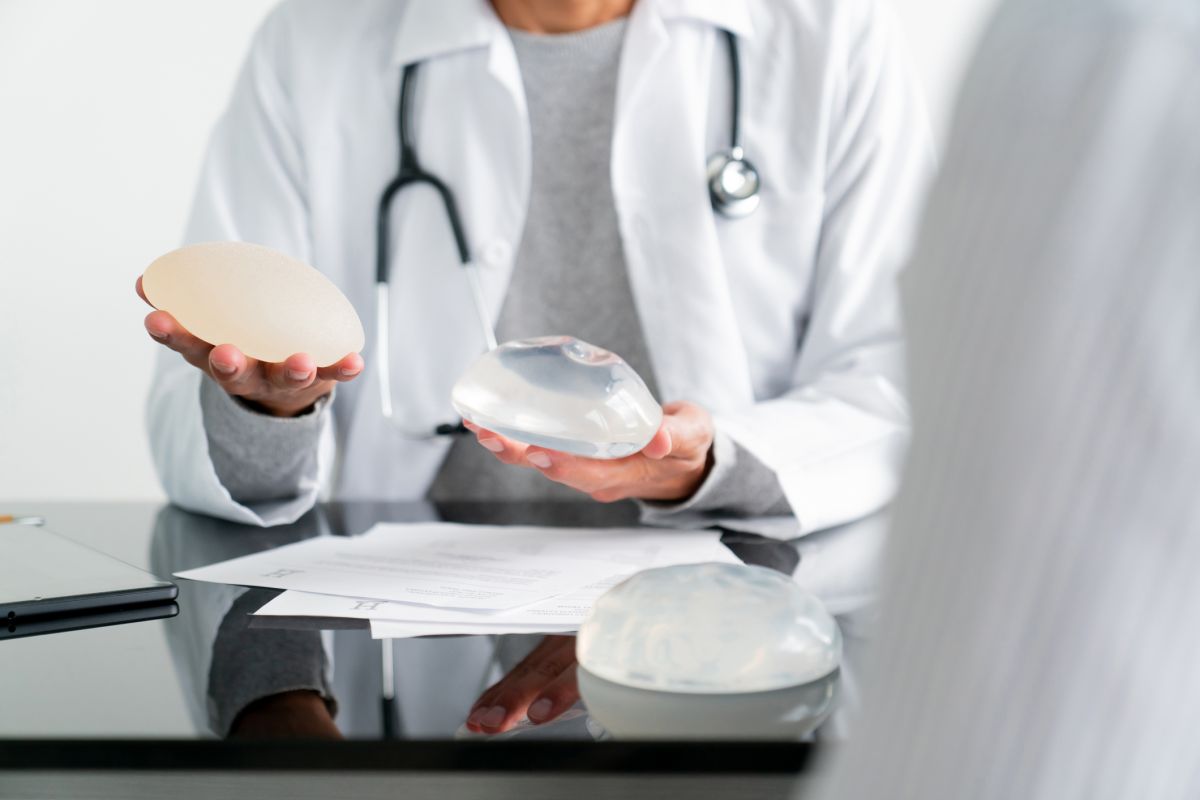 Doctor showing patient breast filler