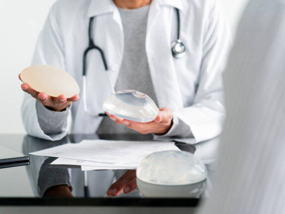 Doctor showing patient breast filler