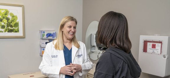 Doctor answering patient questions in exam room