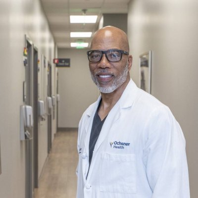 Doctor posing in hallway wearing white coat