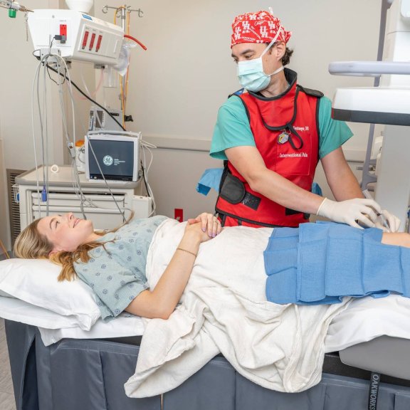 Clinician performing procedure on woman on exam table