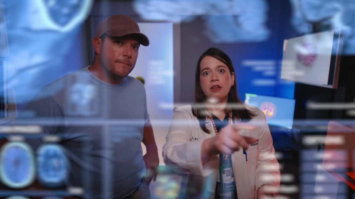 Man and woman looking at AI