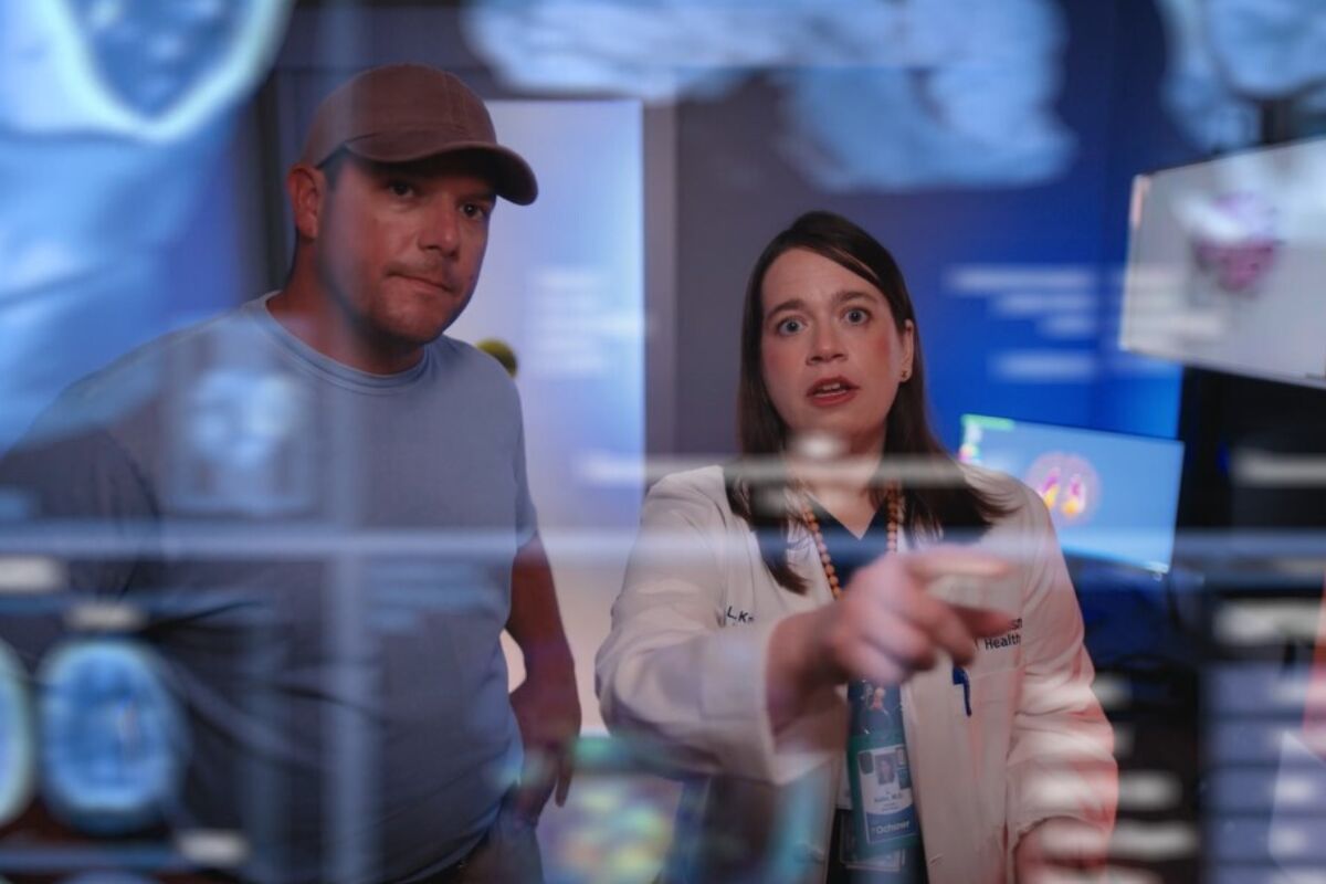 Man and woman looking at AI