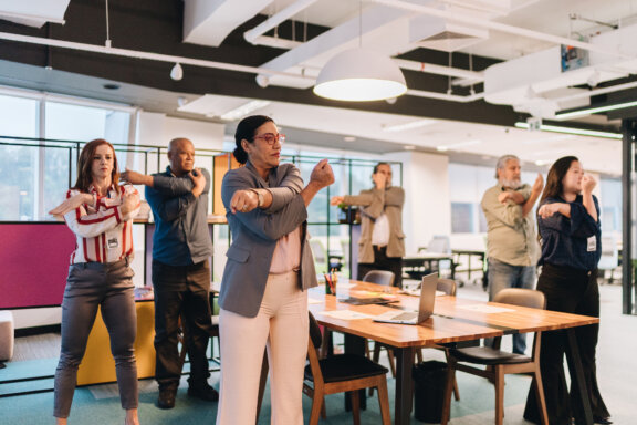 Employees stretching in conference room