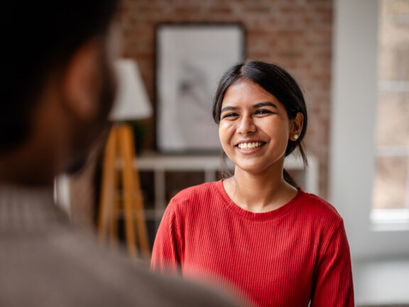 Patient smiling talking to doctor