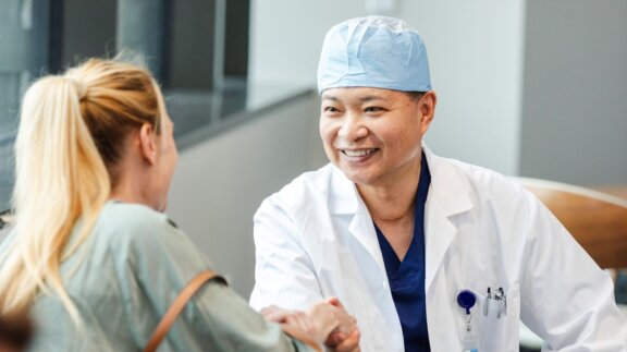 Doctor shaking patients hand in waiting room