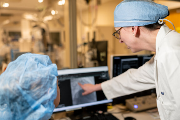 Cardiac surgeon looking at images of an aorta.