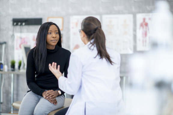Woman talking to doctor