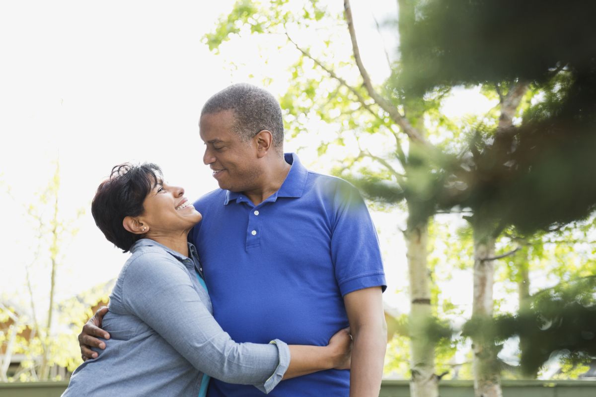 Older couple outside hugging