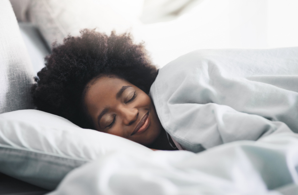 Woman sleeping peacefully and smiling in her sleep
