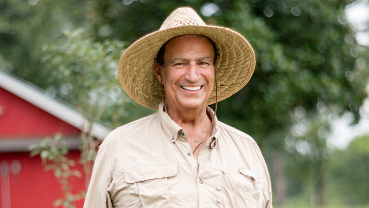 Cardiology patient Dale R outside with hat