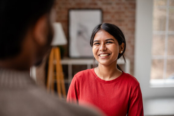 Patient smiling talking to doctor