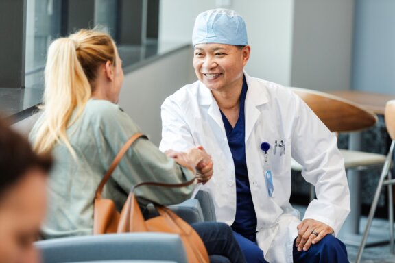 Doctor shaking patients hand in waiting room