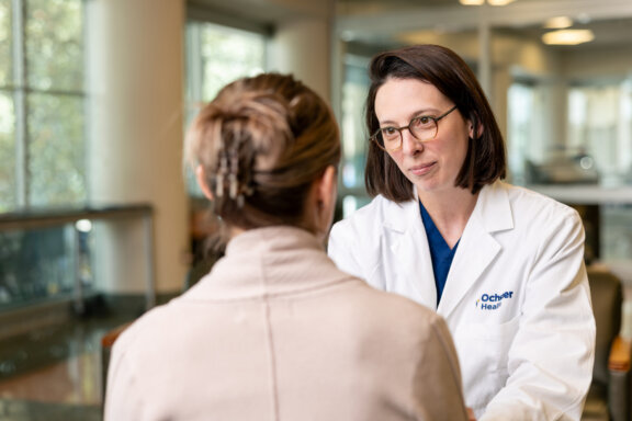 Cardiac surgeon speaking with a patient.