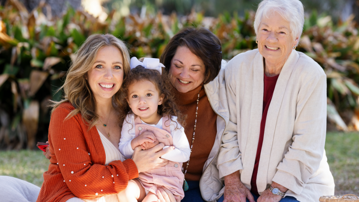 Four generations of women smiling