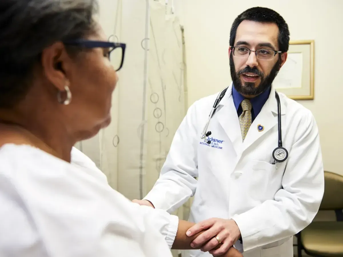 Doctor checking arm of a patient