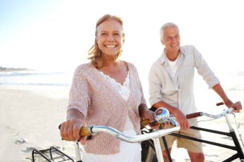 Man and Woman riding bikes on the beach