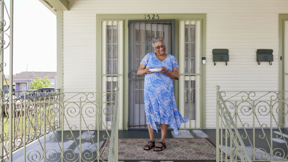 breast cancer patient standing on porch holding gumbo bowl