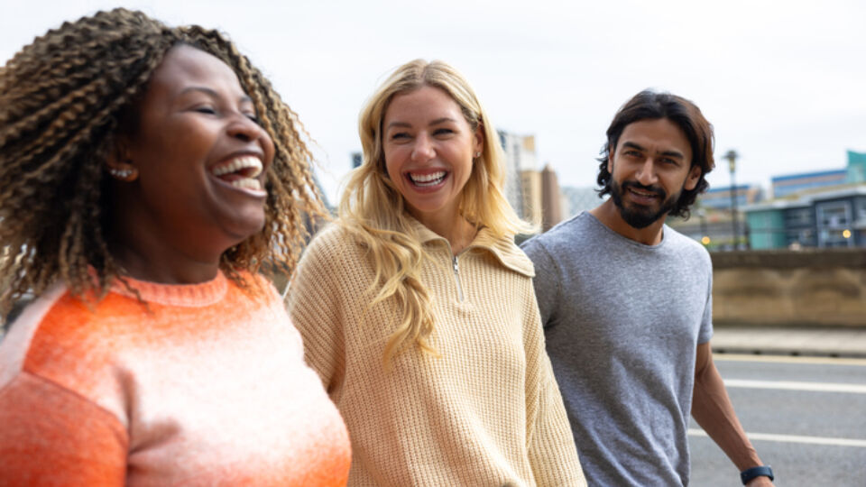 Women and endocrine surgery patient walking outside laughing