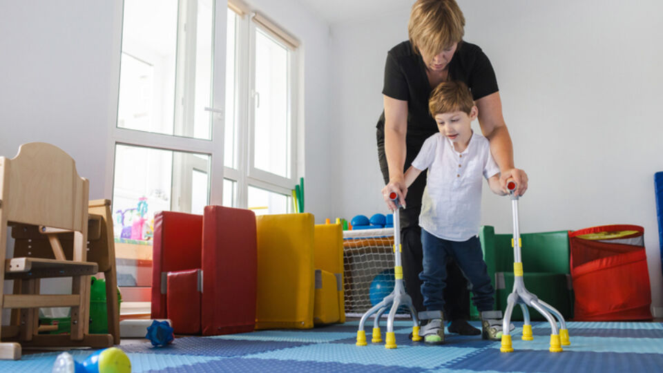 Pediatric rehabilitation patient walking with therapist