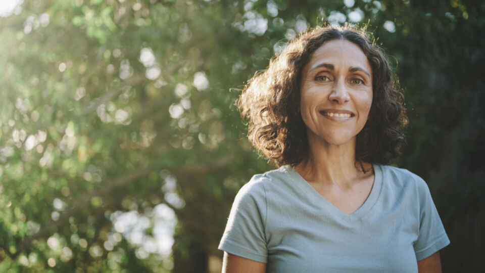 Smiling woman standing outside